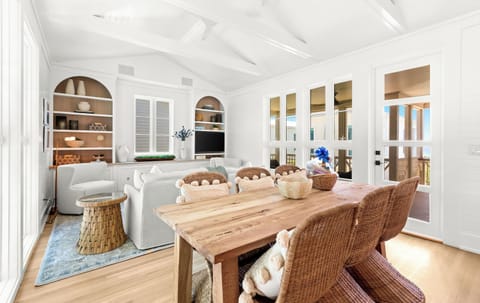 Picture yourself gathered around this rustic wood dining table in your bright, airy retreat. Vaulted ceilings and coastal charm invite you to relax and make memories.