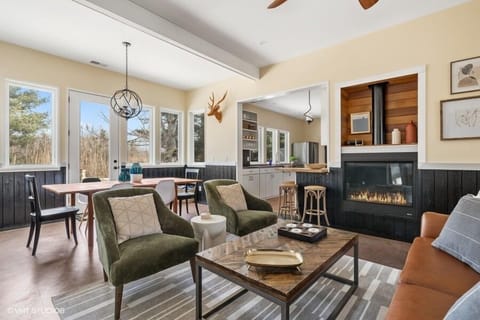 The living room features a cozy fireplace, lots of light and great views of the patio and backyard.