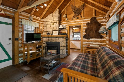 Unwind by the stone fireplace after a day exploring Door County. Cozy seating, warm lighting, and classic cabin charm.