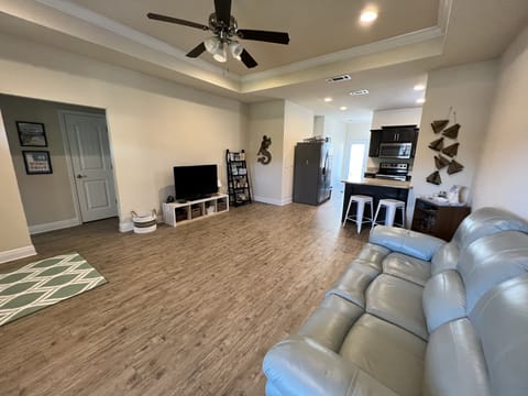 Featuring tray ceiling and ceiling fan, this spacious room welcomes you in. 