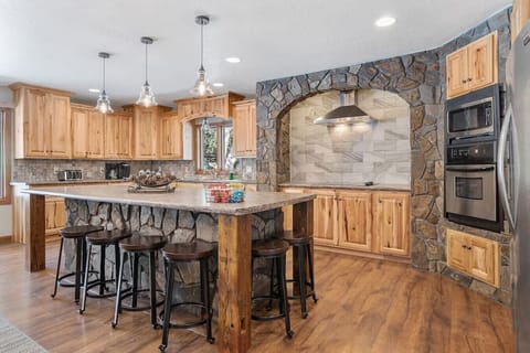 Large Kitchen Counter Top With Six Bar Stools.