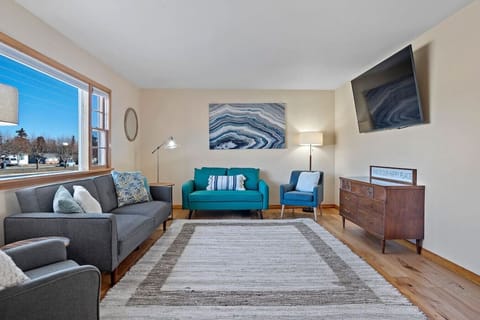Our home has a large living room with a Smart TV, comfy couch, lamps, and a huge window!