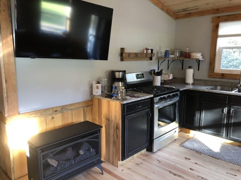 Kitchen with gas fireplace & flat screen TV.