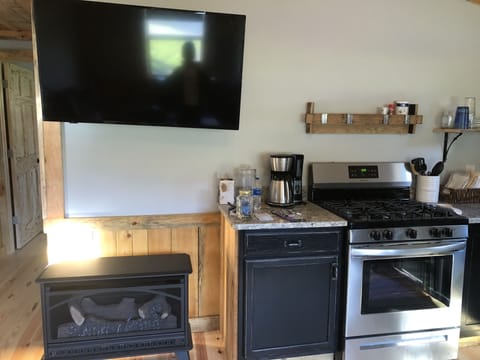 Kitchen with gas fireplace & flat screen TV.