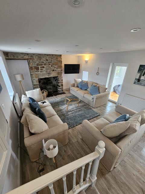 A spacious lounge with a log burner, large TV and comfy sofas to chill out on.