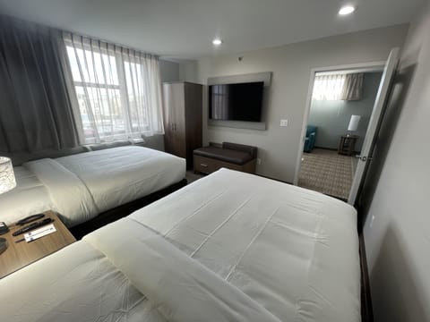 Suite, 2 Double Beds, Non Smoking | Desk, laptop workspace, WiFi (free), bed sheets