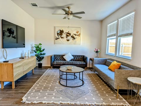 Spacious living room with 65 inch TV and 2 comfortable couches to relax