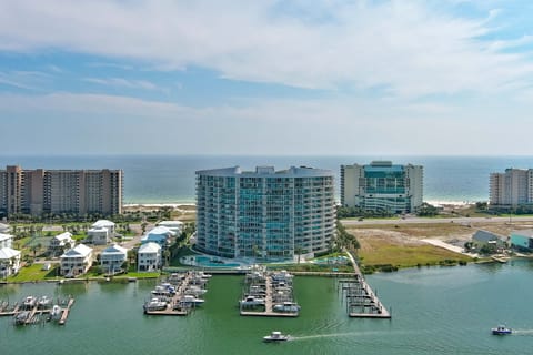 A serene marina scene unfolds, with the vast expanse of the Gulf of Mexico providing a breathtaking backdrop. The gentle rhythm of the bay meets the boundless energy of the open sea.