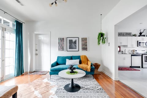 Bright and open living room/kitchen layout. The living room has a 40" smart tv for entertainment and playing music.