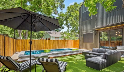 Backyard with pool, plenty of patio furniture, & string lights