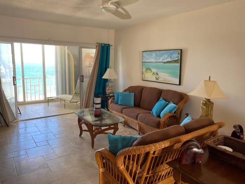 Living room and outside seating leading to balcony