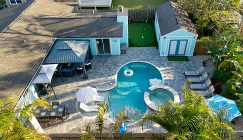 Heated pool surrounded by lush tropical landscaping