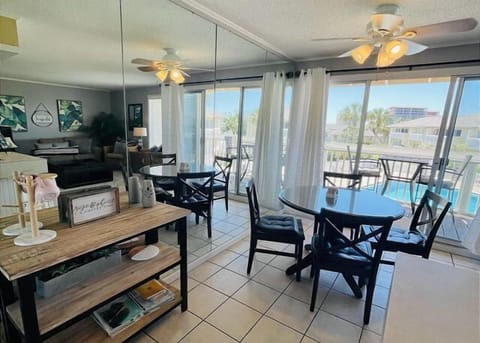 Your bright living space opens to a private balcony with ocean views, where ceiling fans keep you cool and natural light fills every corner.