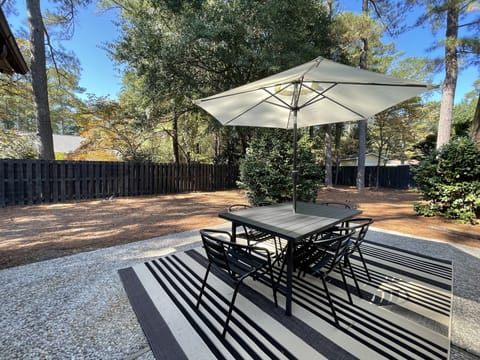 Private back yard with seating for six under shade.