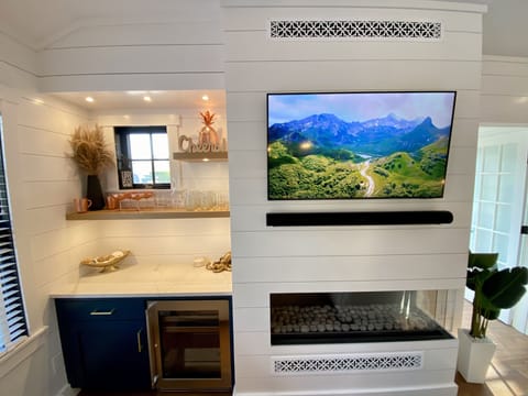 Wet bar in living room with fire place 