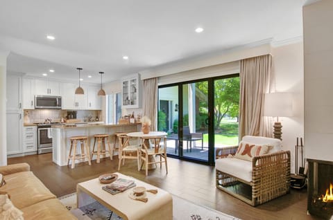 Enjoy the cozy ambience of the fireplace and easy access to the balcony in the condo’s living room. the convenience of the open-concept plan where living room, dining area, and kitchen are close together.