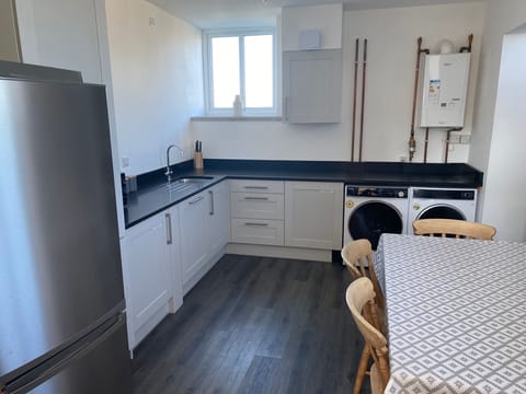Utility room with dishwasher,washing machine,dryer and additional fridge freezer
