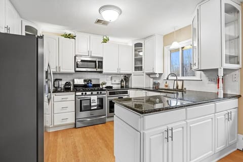 Kitchen features high-end appliances, gas stove, two ovens.