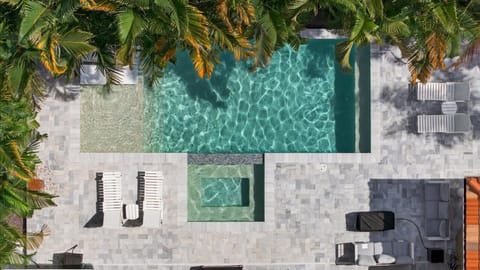 Secluded backyard oasis with heated pool and loungers