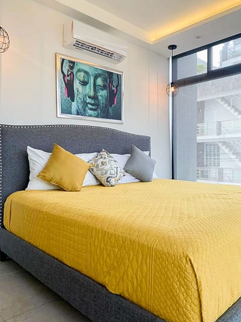 Cozy bed with yellow sheets, find comfort and relaxation at our Playa del Carmen accommodation