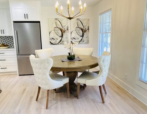 Dining table and chairs next to the kitchen island with bar seating as well.