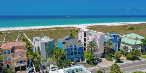 Head upstairs to the shared rooftop deck and watch the sunset fade behind palm silhouettes and the shimmering Gulf.