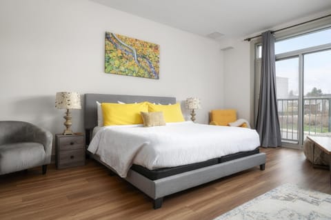 Bright and airy bedroom with city views and cozy seating