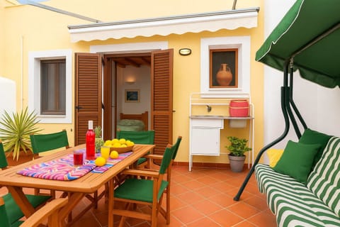 Private balcony of the villa – Outdoor seating with a swing and dining area.
