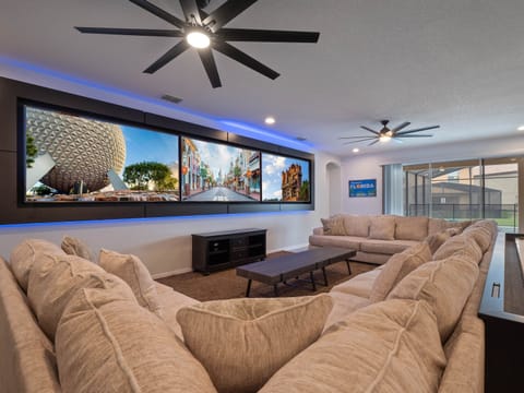 - Relax in the spacious living room with oversized sectional sofa  
- Watch movies on large wall screens with family and friends  
- Vacation home in Orlando offering comfort and entertainment
