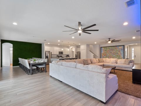 - Spacious open living and dining with kitchen for family meals
- Seating for large groups with cozy sectional and bright space
- Orlando vacation home with modern design and family comfort