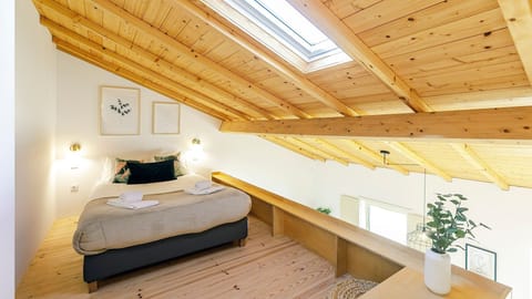 Drift to sleep under a charming wooden ceiling in this cozy loft bedroom, bathed in soft light from the skylight.
#LoftBedroom #CozyBedroom #LovelyStay