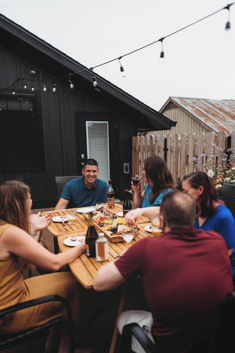 Rooftop Patio Barn Burner Family Long Table Meal Laughing Together Portrait