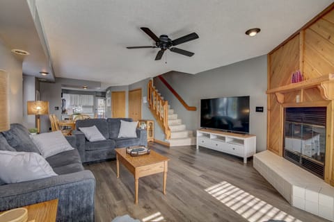 Living room with couch, loveseat, reclining chair and smart TV. (Due to code, fireplace is not available for guest use.)