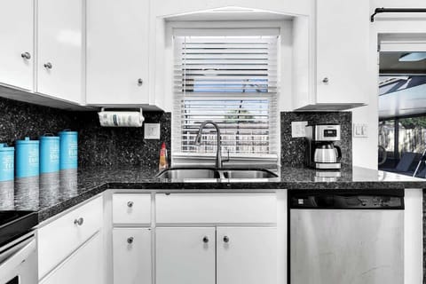 Cook with ease in our fully equipped kitchen! Featuring sleek stainless steel appliances, granite countertops, and a coffee station. This modern space is perfect for preparing family meals during your getaway.
