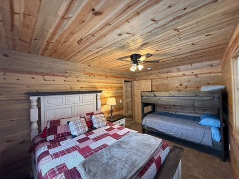 main floor bedroom with a queen bed and bunk bed 