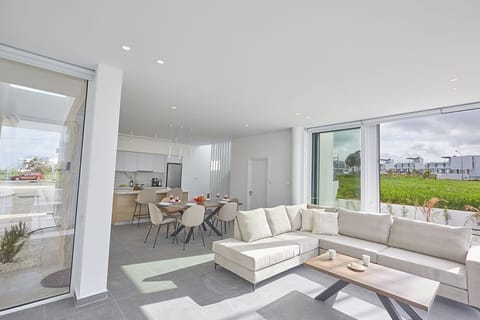 Living room with comfortable corner sofa, coffee table and Smart TV