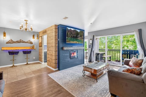 Cozy living room with fireplace, Netflix, and private balcony views.