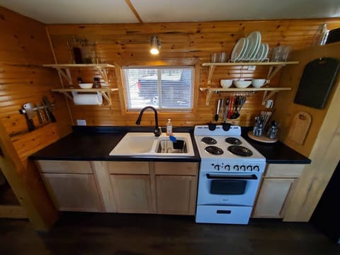 Kitchen sink and stove with oven.