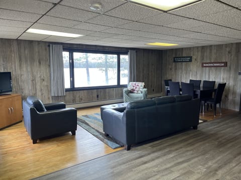 Spacious living room with oversized picture window overlooking the lake