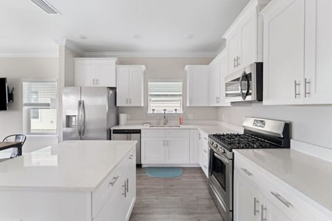 Fully equipped kitchen with all cooking and baking supplies, gas stove, and dishwasher. Grill tools available for outdoor grill. Dining area seats 6 with 4 at the table and 2 at kitchen island. Regular drip coffee maker.