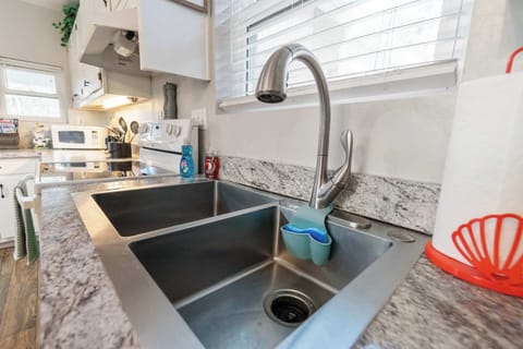 Modern kitchen sink with dual basins and sleek pull-down faucet.