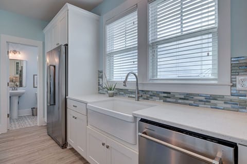 Fully stocked kitchen with coffee maker and Keurig machine. Farm sink.