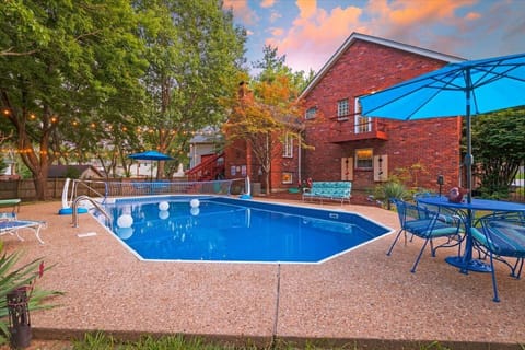 View of swimming pool and back of house at Sunset