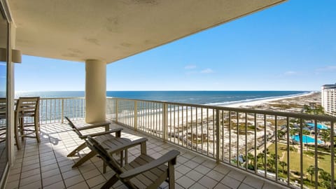 Gain a new perspective on coastal beauty with this panoramic view.  Witness the vastness of the beach and the shimmering sea.