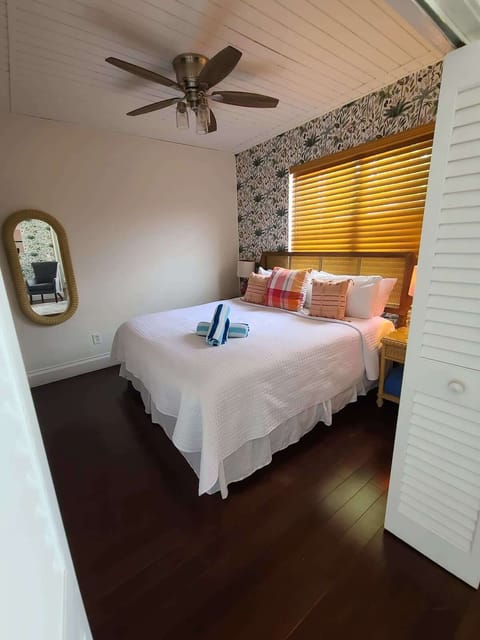 Paradise suite king bed with ceiling fan and 50' smart tv connected to Hulu live tv