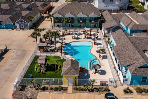 Aerial View of Sparkling Community Pool & Relaxing Lounges