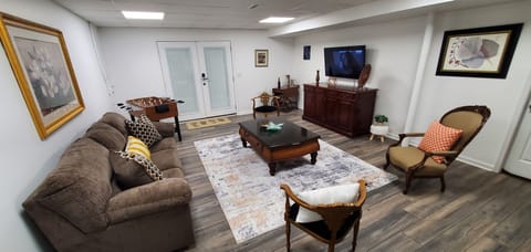 Warm and inviting living area with fully loaded fire TV and 3 in one game table