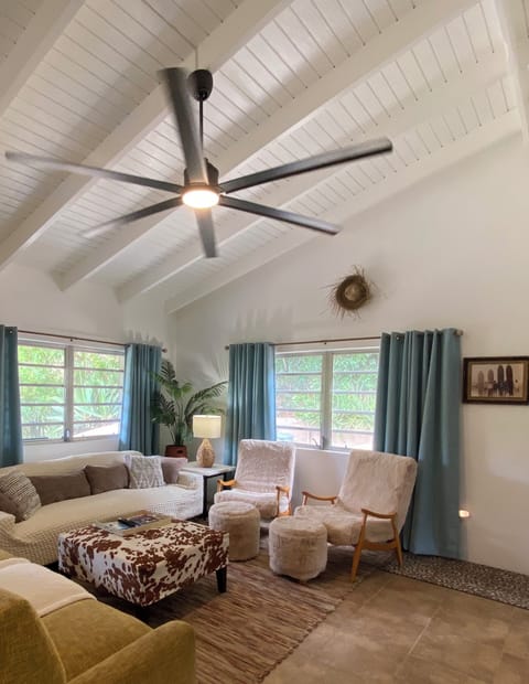 living room with ceiling fan TV and AC