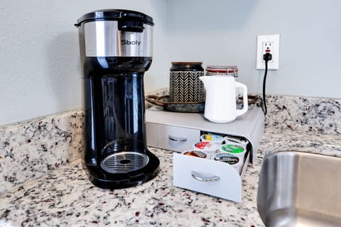 Keurig-style coffee maker with coffee, sugar, and creamer; variety of spices supplied; there is also a single serve French press coffee maker.