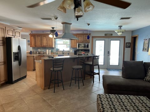 Kitchen Breakfast bar island Doors to pool deck 